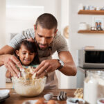 father and daughter making breakfast