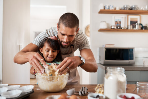 father and daughter making breakfast