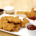 Thanksgiving chicken nugget dipping in sauce