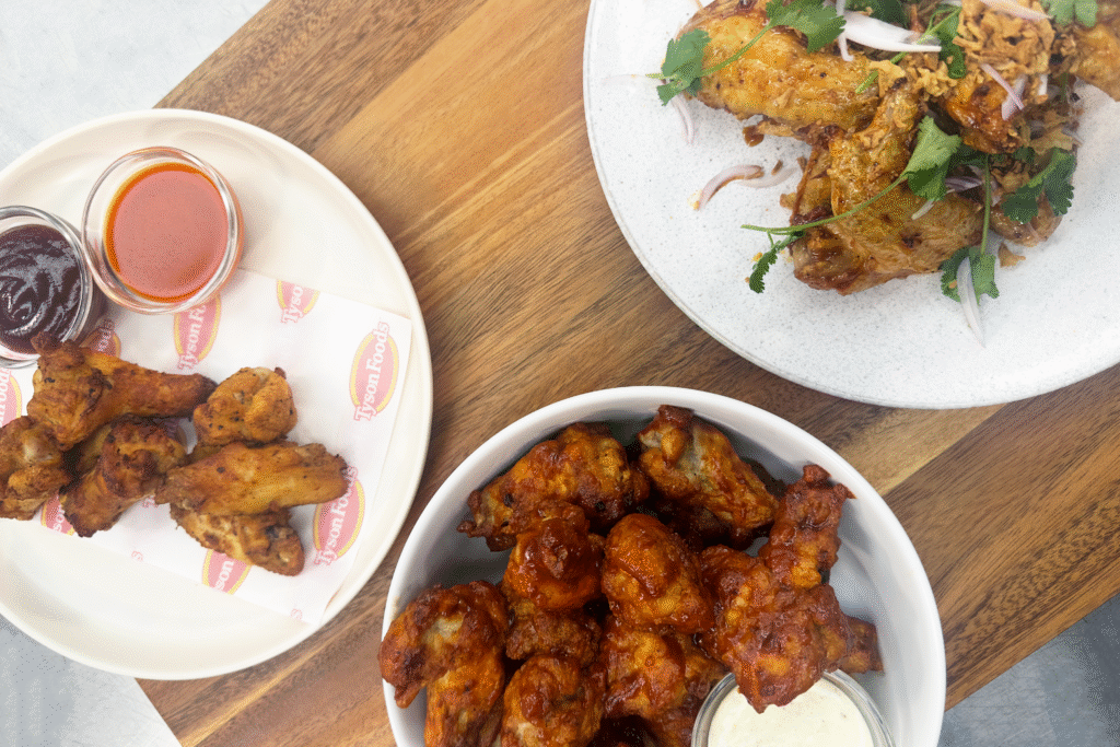Three plates of different chicken wings.