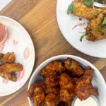Three plates of different chicken wings.